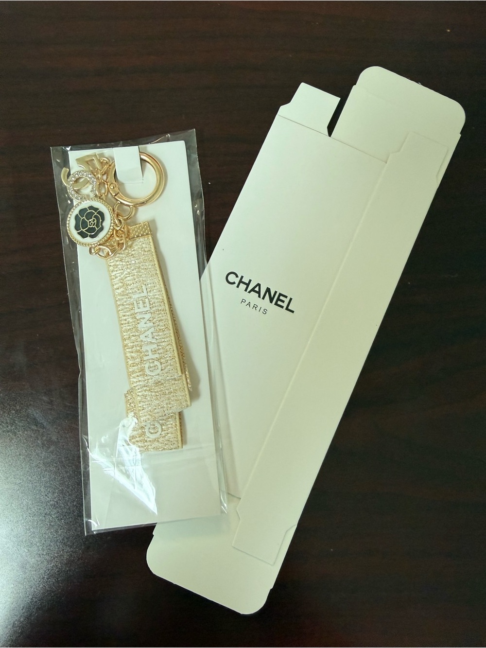 CHANEL Gold Metallic Logo Strap Key Holder with Camellia Charm